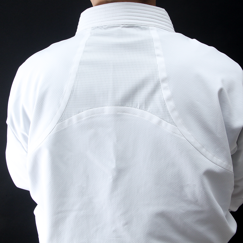 Close-up of a Hayate white karate jacket with breathable back on a black background